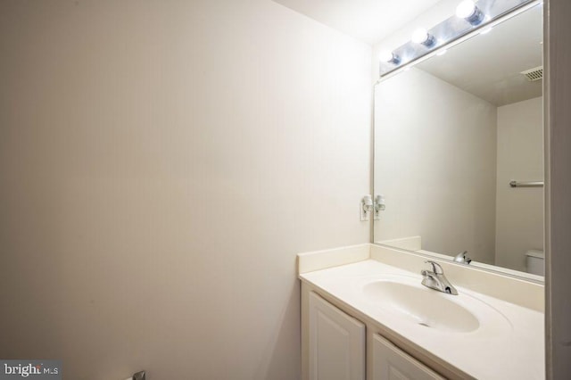 bathroom featuring vanity and toilet