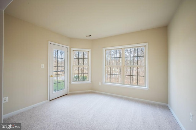 empty room featuring light colored carpet