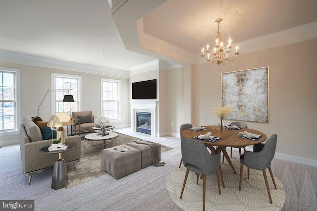 dining room with ornamental molding, plenty of natural light, and light colored carpet