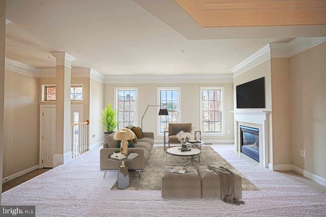 carpeted living room featuring crown molding and ornate columns