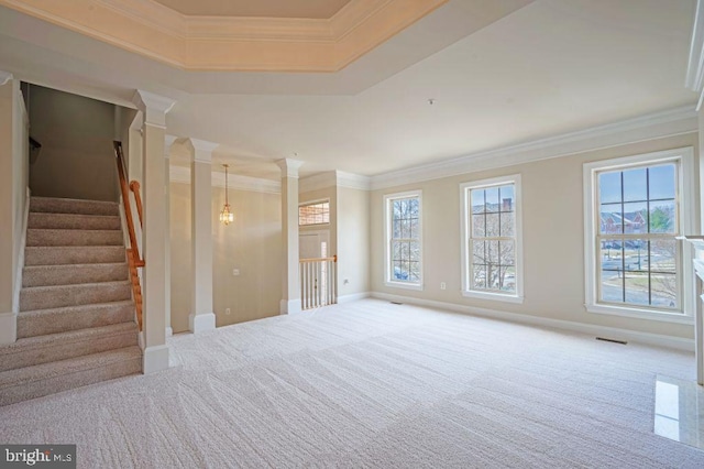 unfurnished room with crown molding, light colored carpet, and decorative columns