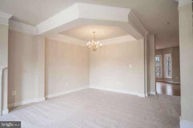 empty room featuring crown molding, carpet flooring, and a notable chandelier