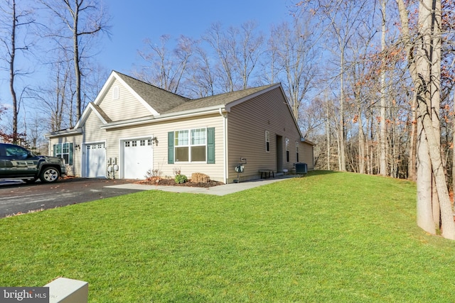 view of side of property featuring a yard and a garage