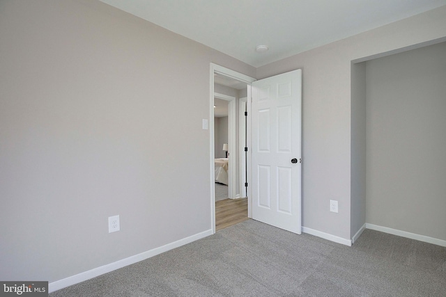 unfurnished bedroom with light colored carpet