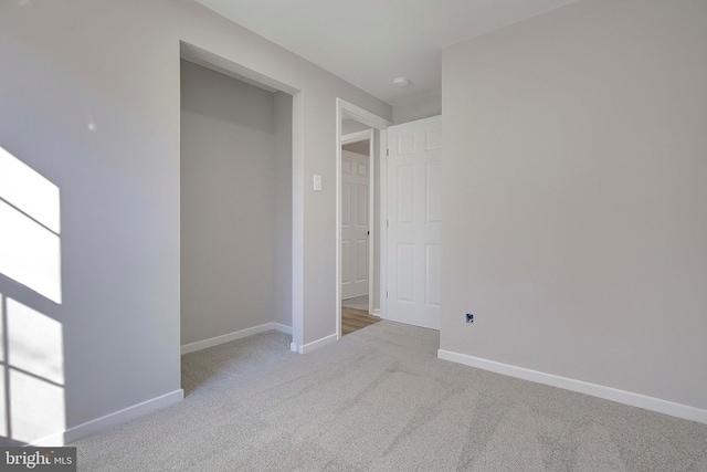 unfurnished bedroom with light colored carpet