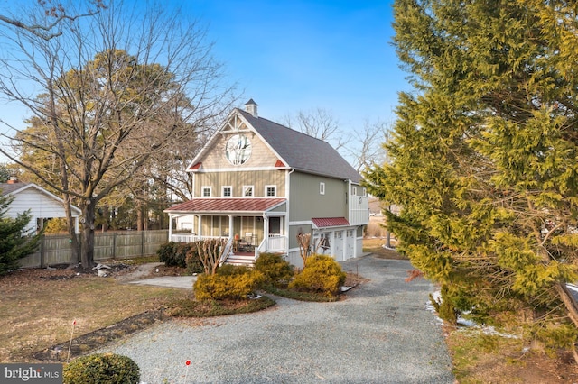 view of property featuring a porch and a garage