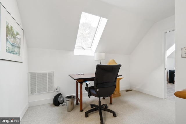 office with light colored carpet and lofted ceiling with skylight