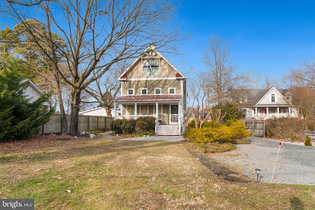 victorian home featuring a porch and a front lawn