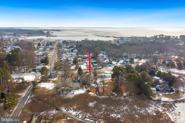 snowy aerial view featuring a water view