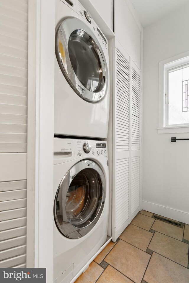 laundry room featuring stacked washer and clothes dryer