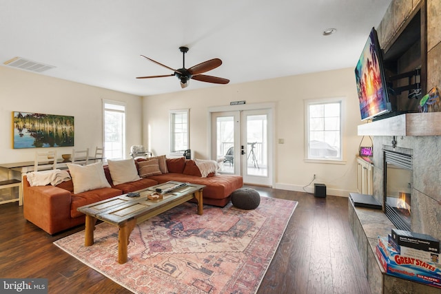 living room featuring dark hardwood / wood-style flooring, a fireplace, and plenty of natural light