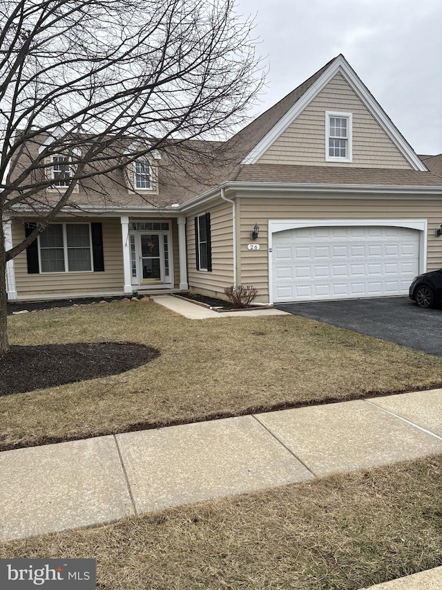 view of front of home featuring a garage and a front lawn