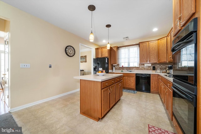 kitchen featuring a kitchen island, pendant lighting, decorative backsplash, and black appliances