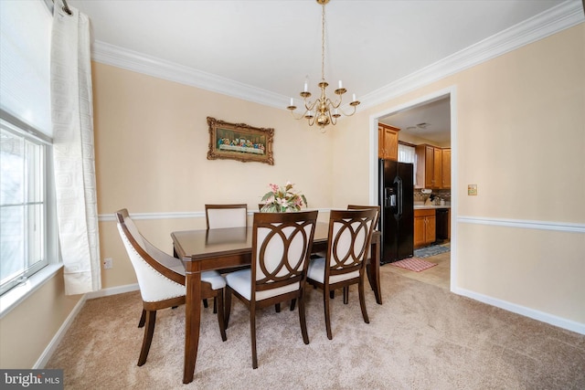 carpeted dining area featuring an inviting chandelier and ornamental molding