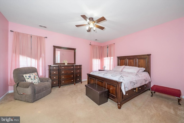 bedroom featuring light colored carpet and ceiling fan