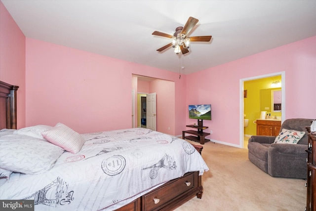 carpeted bedroom featuring ensuite bath and ceiling fan