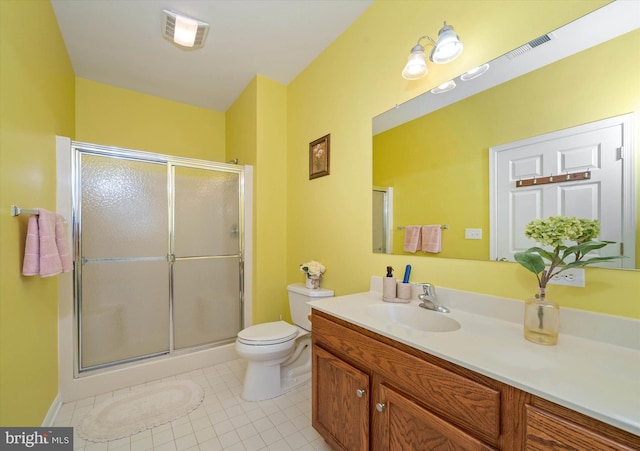 bathroom featuring an enclosed shower, vanity, tile patterned flooring, and toilet