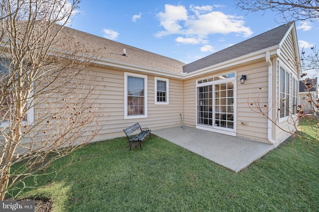 back of house with a yard and a patio area