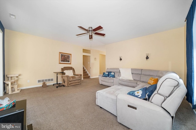 living room featuring ceiling fan and carpet