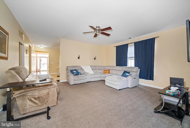 carpeted living room with ceiling fan and plenty of natural light