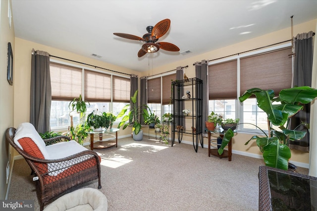 sunroom / solarium featuring ceiling fan