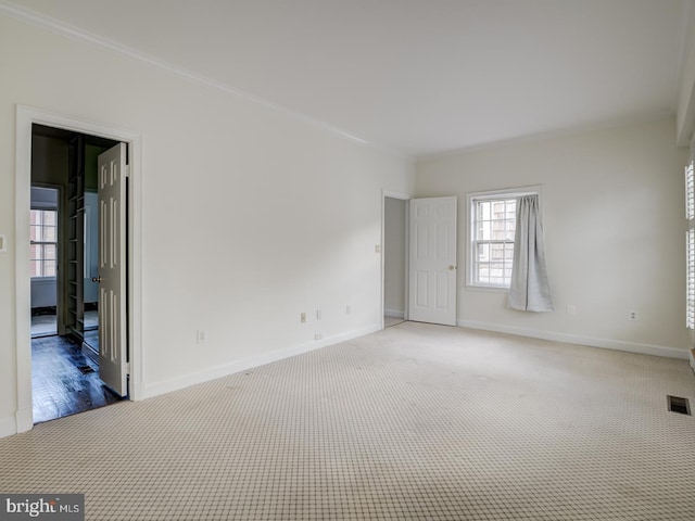 carpeted empty room with crown molding