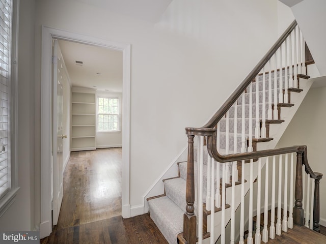 stairway with hardwood / wood-style floors