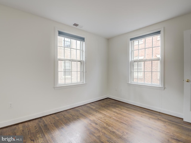 unfurnished room with dark hardwood / wood-style floors