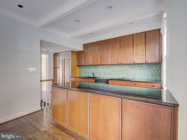 kitchen featuring sink, beam ceiling, dark hardwood / wood-style floors, tasteful backsplash, and kitchen peninsula