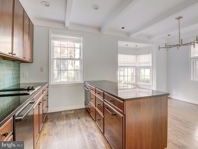 kitchen featuring beam ceiling, kitchen peninsula, light wood-type flooring, and backsplash