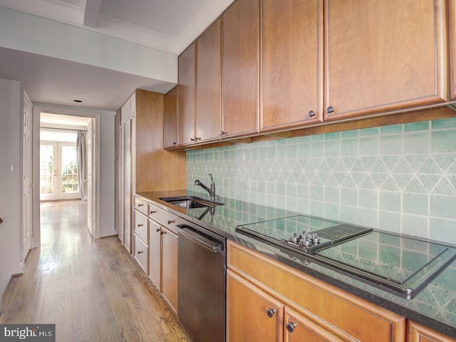 kitchen with dishwasher, sink, decorative backsplash, light hardwood / wood-style floors, and black electric cooktop