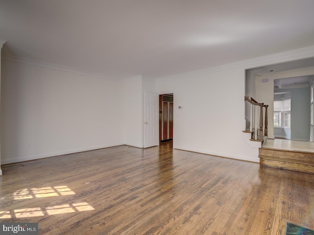 unfurnished room with crown molding and wood-type flooring