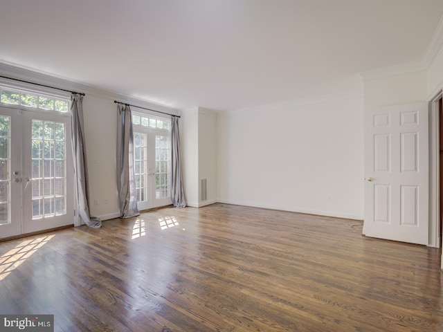 unfurnished room featuring crown molding, dark wood-type flooring, and french doors