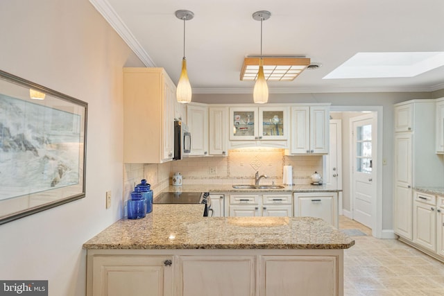 kitchen with a skylight, sink, hanging light fixtures, crown molding, and light stone countertops