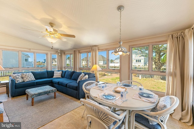 sunroom with ceiling fan and vaulted ceiling