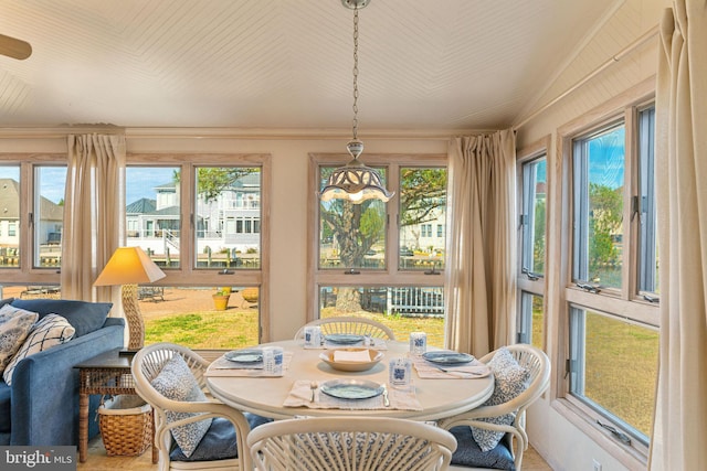 sunroom / solarium featuring a notable chandelier