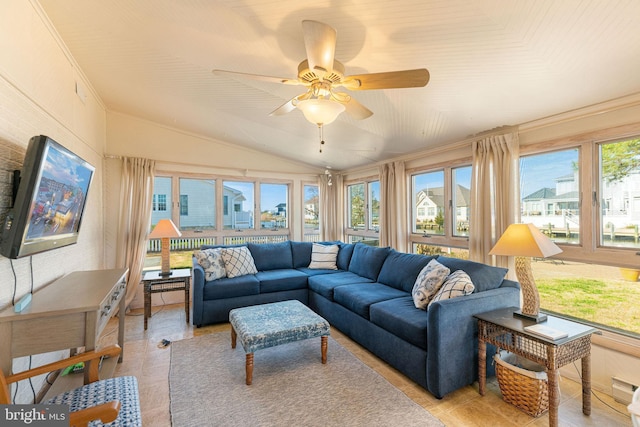 interior space with vaulted ceiling, crown molding, light tile patterned floors, and ceiling fan