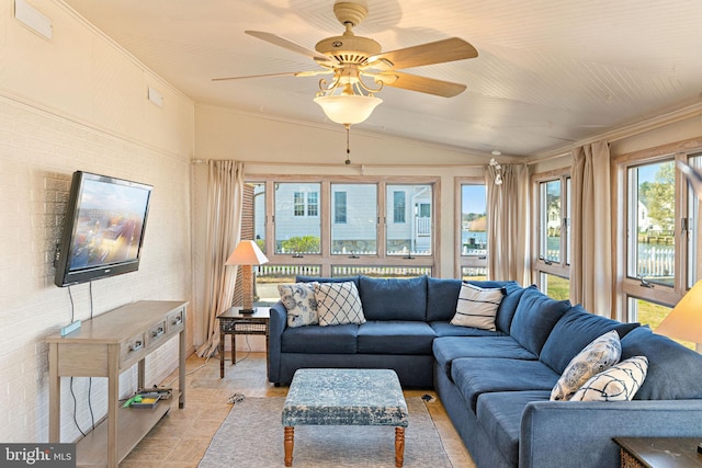 living room with crown molding, ceiling fan, and vaulted ceiling