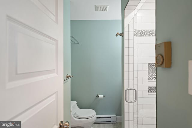 bathroom featuring a baseboard radiator, toilet, and an enclosed shower