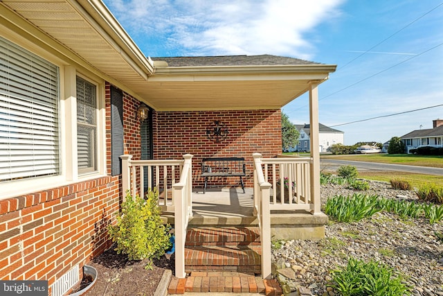 view of exterior entry with covered porch