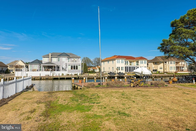 dock area with a water view and a yard