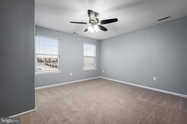 unfurnished room featuring ceiling fan and light colored carpet