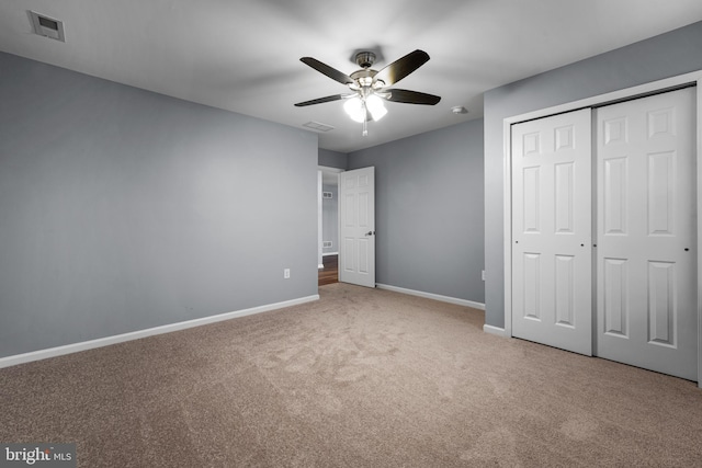 unfurnished bedroom featuring carpet flooring, ceiling fan, and a closet