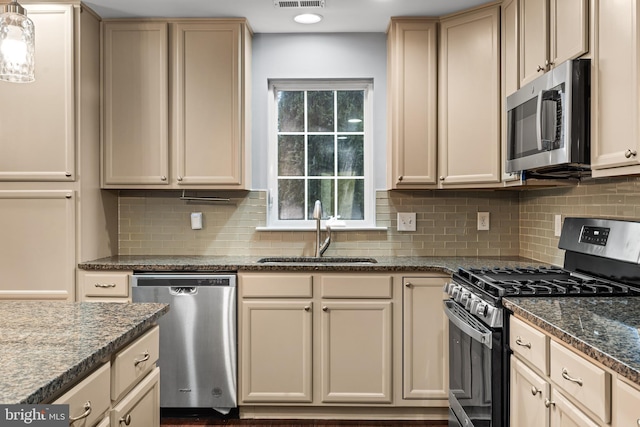 kitchen featuring tasteful backsplash, appliances with stainless steel finishes, and sink