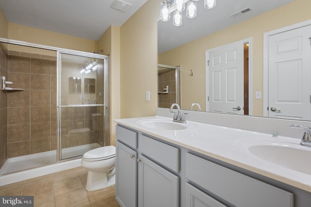 bathroom featuring vanity, walk in shower, tile patterned floors, and toilet