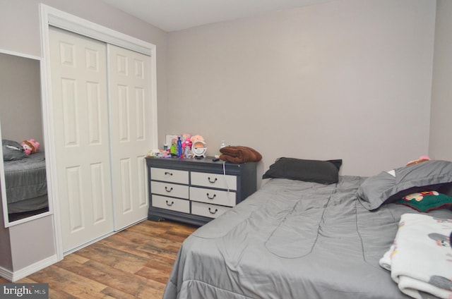 bedroom featuring dark hardwood / wood-style flooring and a closet