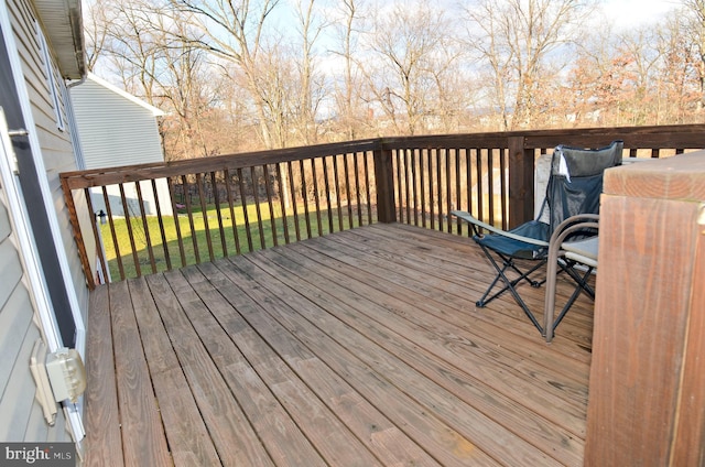 wooden terrace featuring a yard