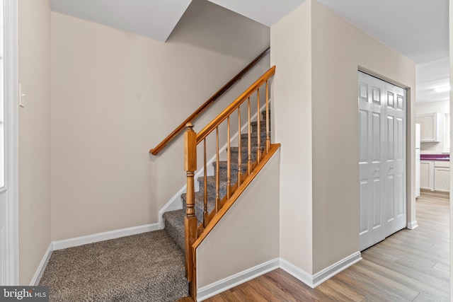 stairs with wood-type flooring