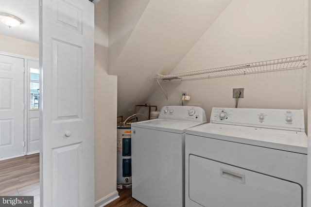 washroom with wood-type flooring and washing machine and clothes dryer