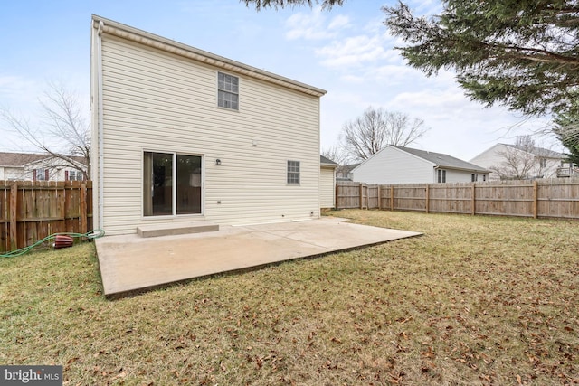 back of property featuring a yard and a patio